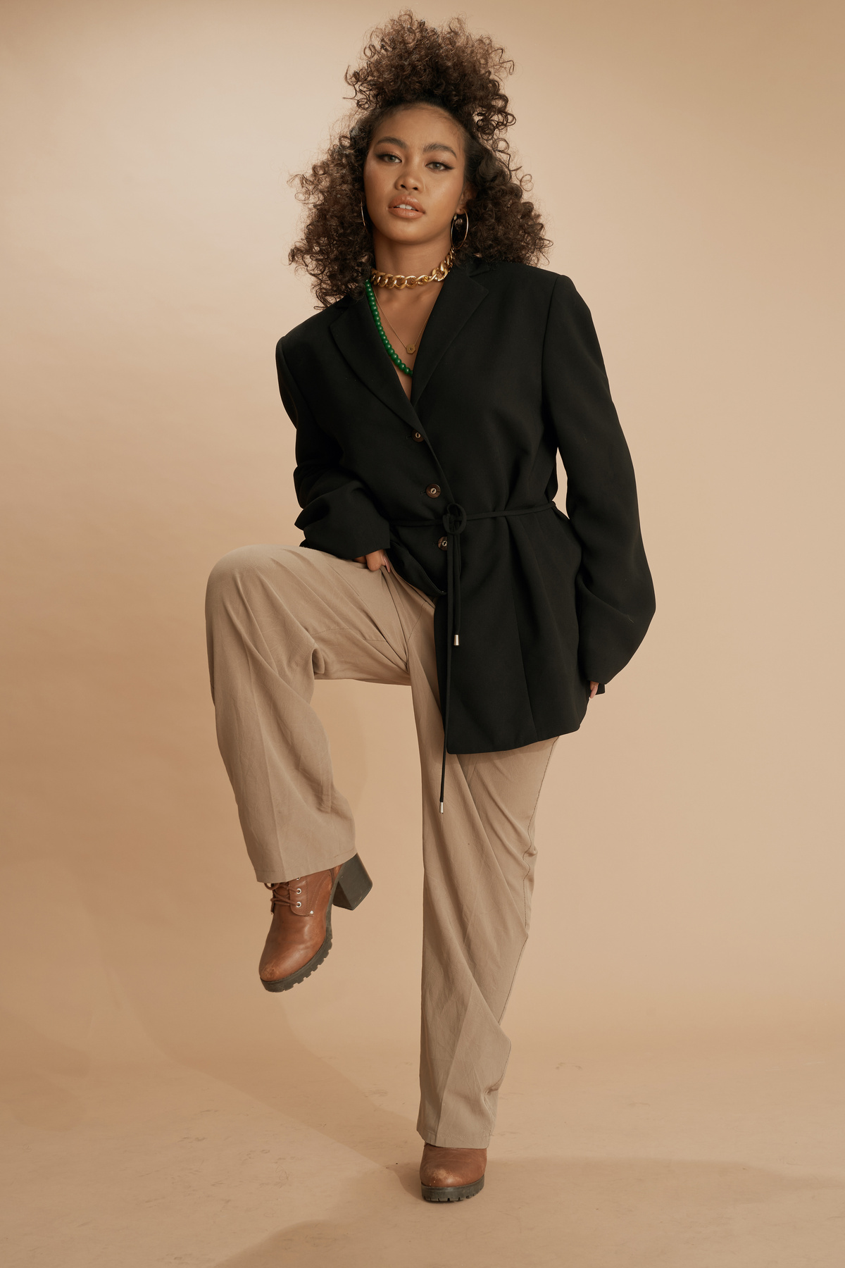 Curly-Haired Woman Wearing a Black Suit Jacket